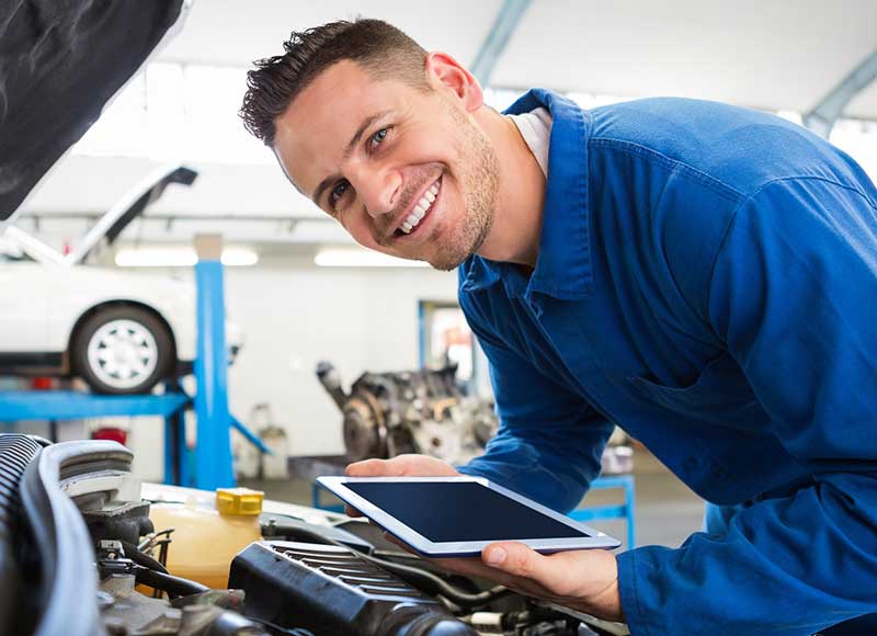 Service mechanic working on car